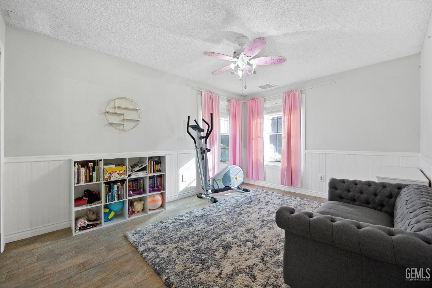 Undisclosed Address Bakersfield, CA 93308 - Photo 31 of 48 a living room with furniture and a bookshelf