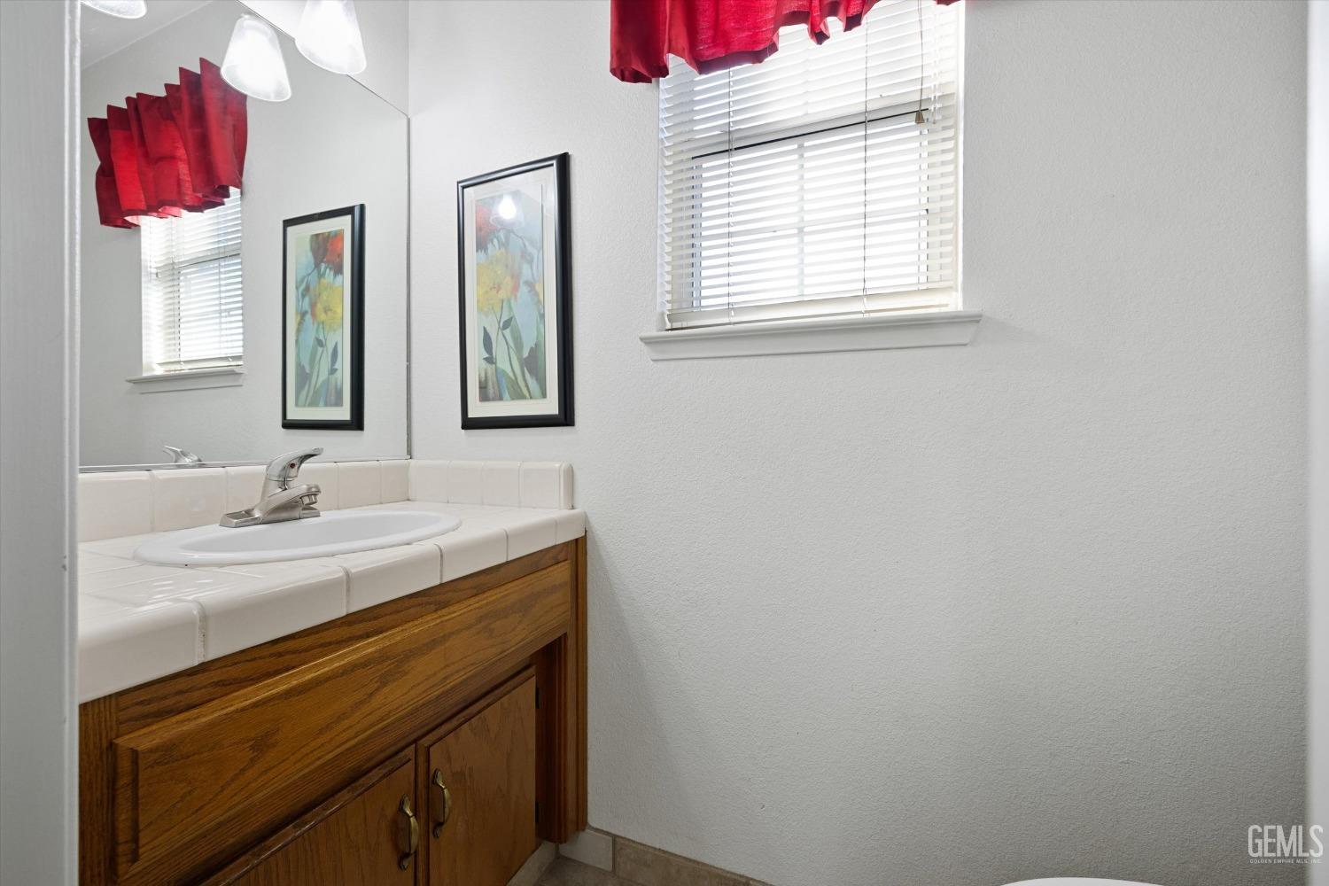 Undisclosed Address Bakersfield, CA 93308 - Photo 33 of 48 a bathroom with a sink vanity and a mirror