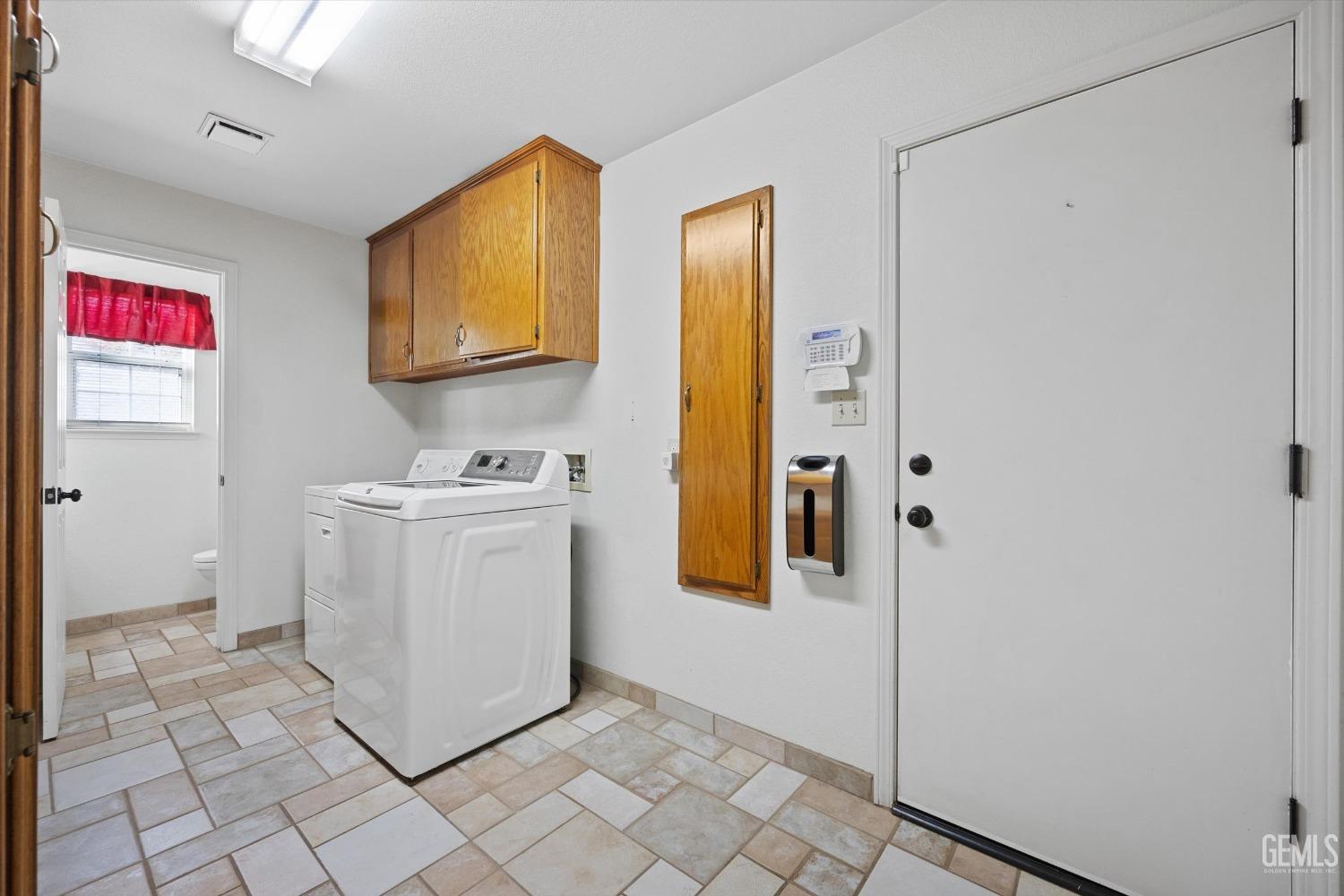 Undisclosed Address Bakersfield, CA 93308 - Photo 36 of 48 a utility room with cabinets washer and dryer