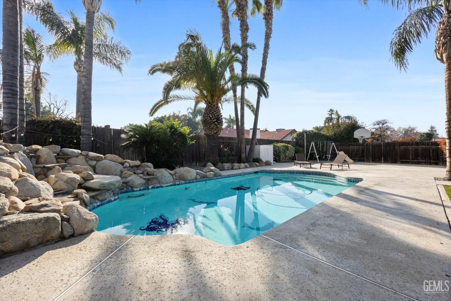 Undisclosed Address Bakersfield, CA 93308 - Photo 40 of 48 a view of swimming pool with a yard and palm trees