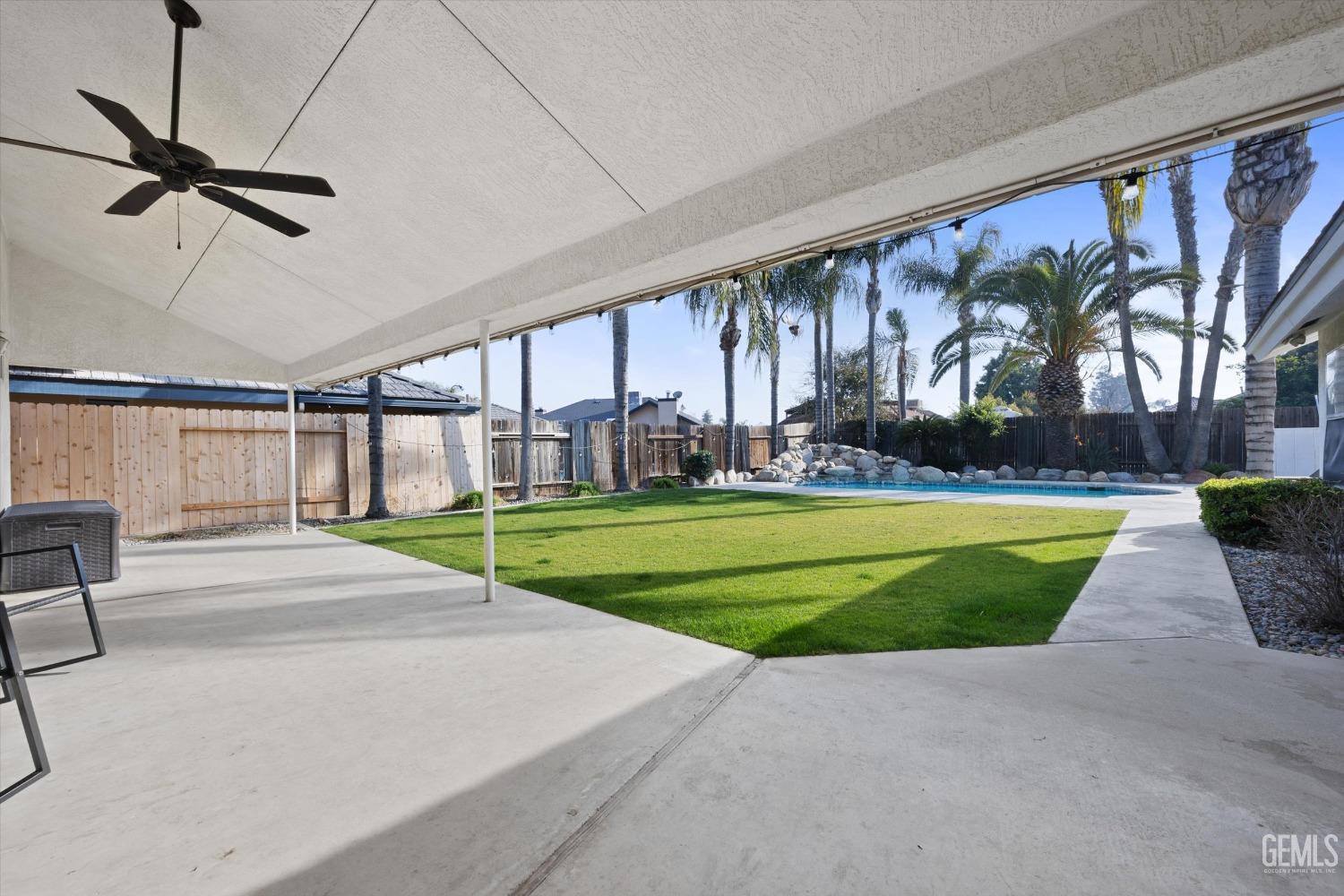 Undisclosed Address Bakersfield, CA 93308 - Photo 43 of 48 a view of a swimming pool with a yard