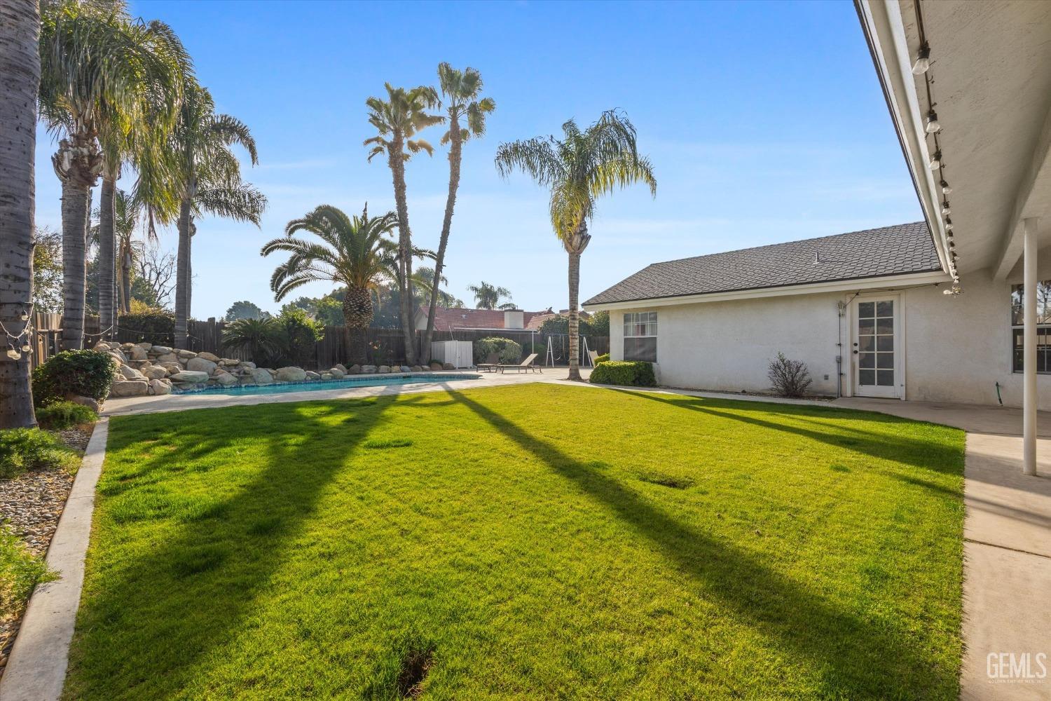 Undisclosed Address Bakersfield, CA 93308 - Photo 45 of 48 a swimming pool with outdoor seating and yard