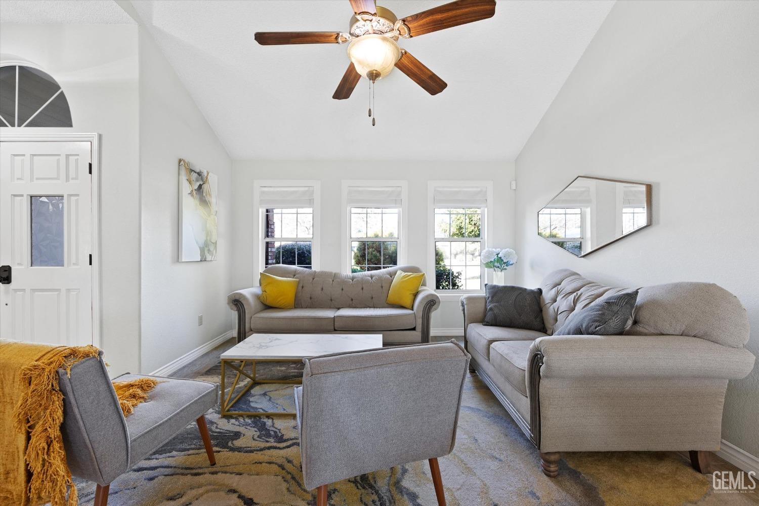 Undisclosed Address Bakersfield, CA 93308 - Photo 8 of 48 a living room with furniture and a chandelier