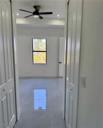 a view of a hallway with wooden shelves
