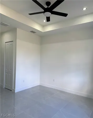 a large white kitchen with kitchen island a sink stainless steel appliances and cabinets
