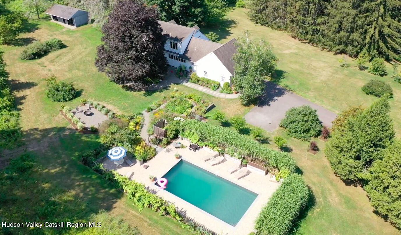 an aerial view of a house with a yard and lake view