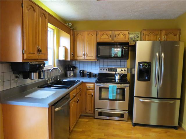 2255 Thompson Road Murfreesboro, TN 37128 - Photo 5 of 20 a kitchen with a refrigerator a microwave a sink and a stove