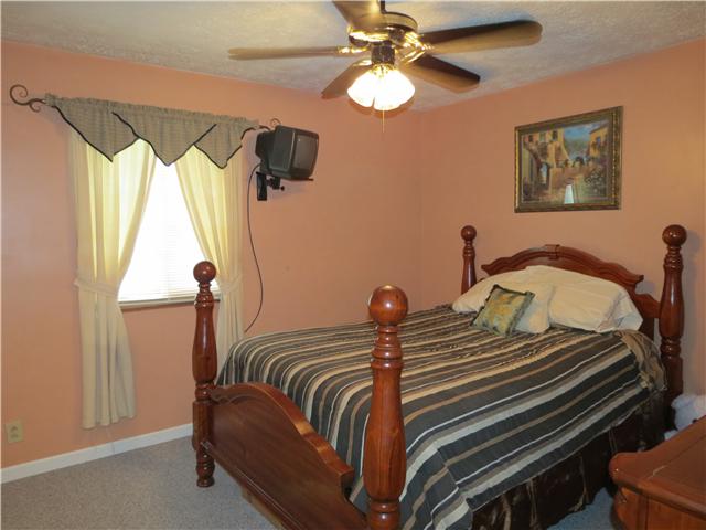 2255 Thompson Road Murfreesboro, TN 37128 - Photo 8 of 20 a bedroom with a bed and a chandelier