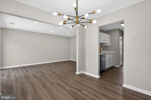 a view of a kitchen with a sink and wooden floor