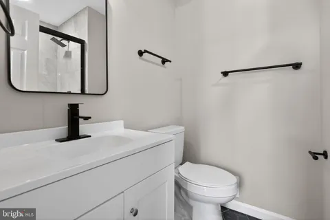 an empty room with ceiling fan and window