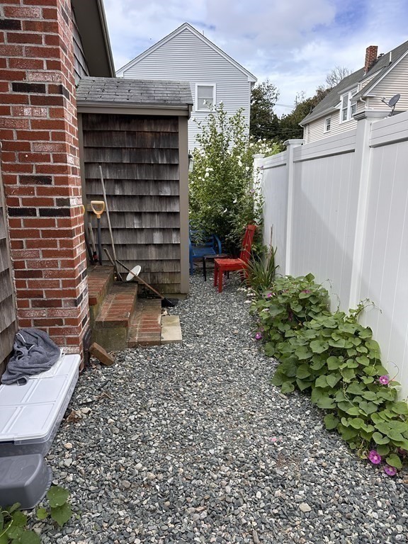 10 Sachem Road Weymouth, MA 02191 - Photo 13 of 19 a view of a backyard with plants and a grill