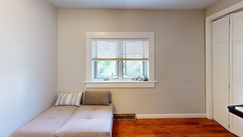10 Sachem Road Weymouth, MA 02191 - Photo 7 of 19 a bedroom with a bed and wooden floor