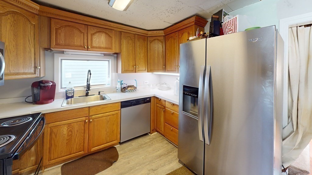 10 Sachem Road Weymouth, MA 02191 - Photo 9 of 19 a kitchen with stainless steel appliances granite countertop a refrigerator and a sink