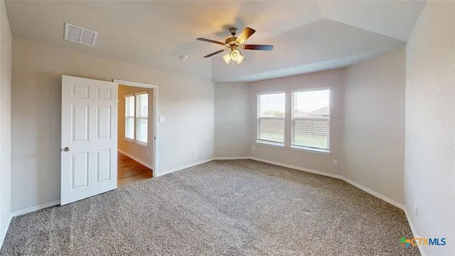 a view of empty room with wooden floor