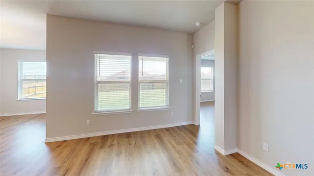 a view of a living room with furniture and a kitchen