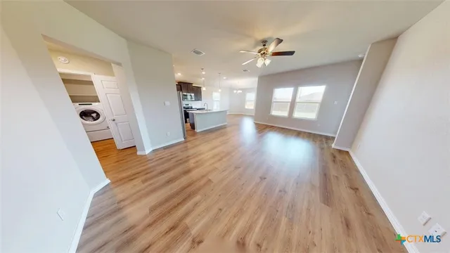 a view of hallway with wooden floor