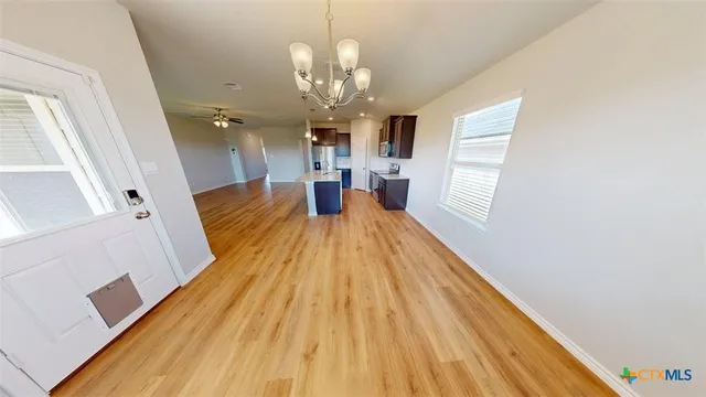 a view of a kitchen with a sink and a wooden floor