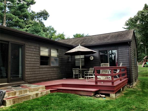 10 Colonial Road Wilbraham, MA 01095 - Photo 4 of 22 a wooden bench sitting in front of a house