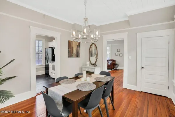 a view of a dining room with furniture and wooden floor