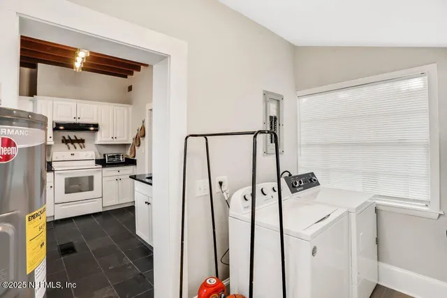 a kitchen with white cabinets and white appliances