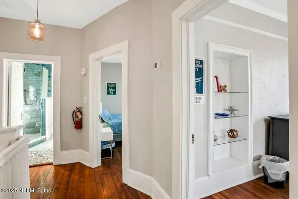 a view of a livingroom with wooden floor and furniture