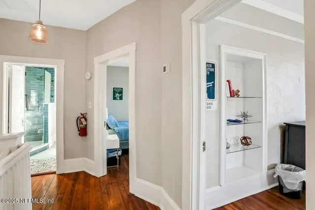 a view of a livingroom with wooden floor and furniture
