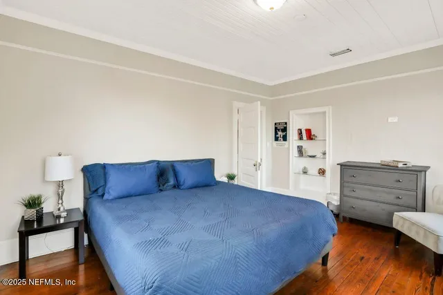 a bedroom with a bed and cabinet