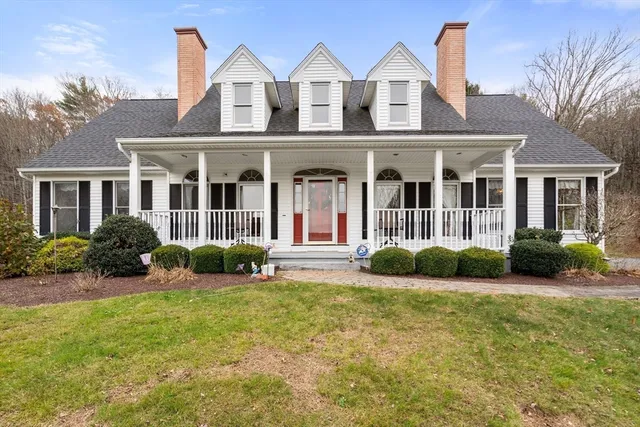 a view of a house with a big yard and potted plants