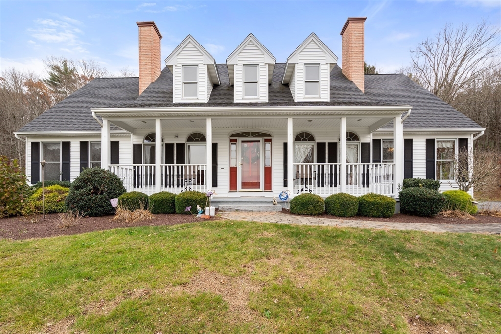 a view of a house with a big yard and potted plants