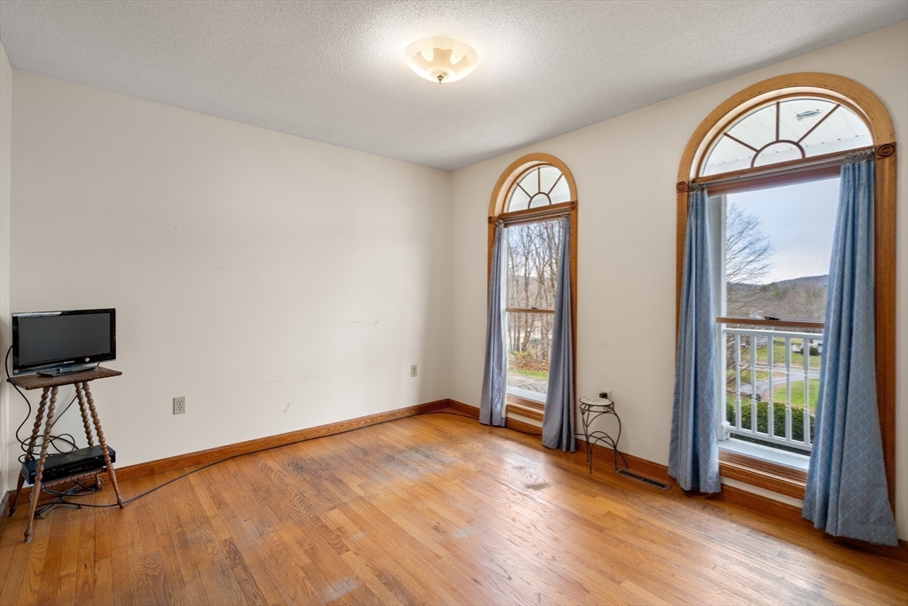 15 Sturbridge Road Brimfield, MA 01010 - Photo 14 of 36 a view of empty room with wooden floor and fan