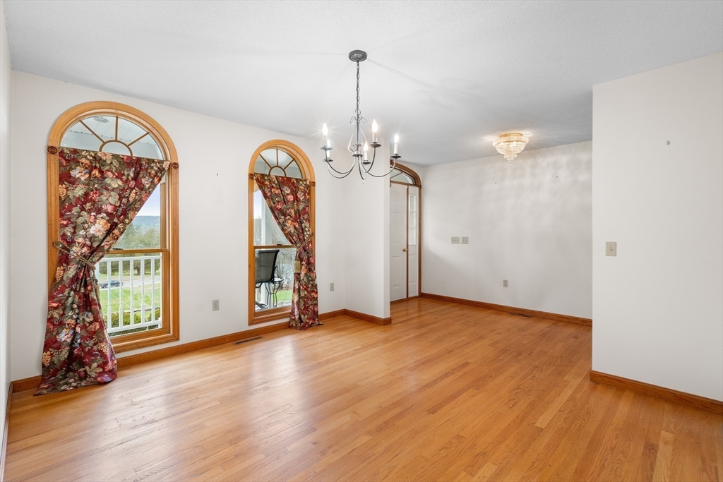 15 Sturbridge Road Brimfield, MA 01010 - Photo 15 of 36 a view of empty room with wooden floor and fan
