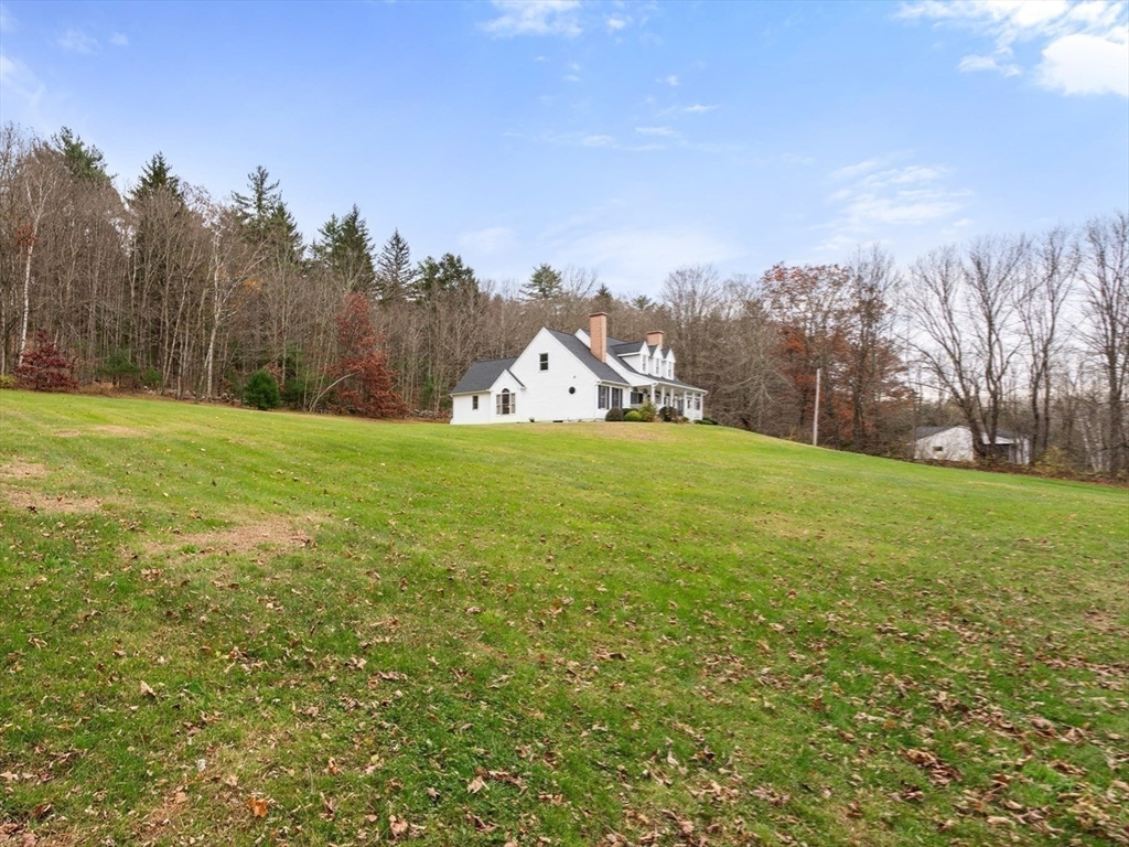 15 Sturbridge Road Brimfield, MA 01010 - Photo 27 of 36 a view of a big yard with a house in the background