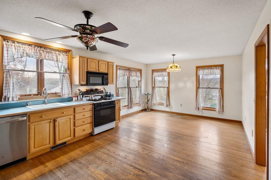 15 Sturbridge Road Brimfield, MA 01010 - Photo 7 of 36 a kitchen with stainless steel appliances granite countertop a stove top oven a sink with wooden cabinets and glass windows