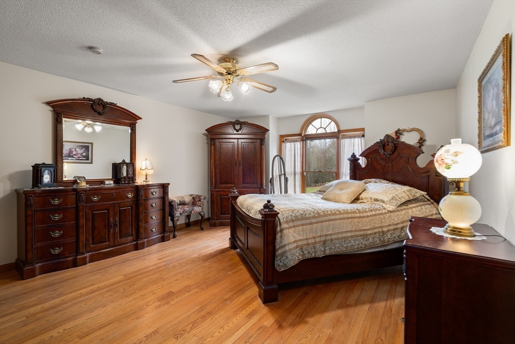 15 Sturbridge Road Brimfield, MA 01010 - Photo 10 of 36 a bedroom with a bed and a chandelier