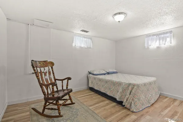 a bedroom with a bed chair and window