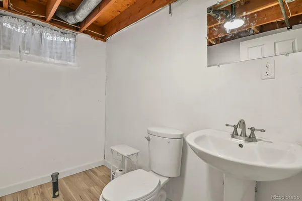 a bathroom with a sink a toilet and mirror