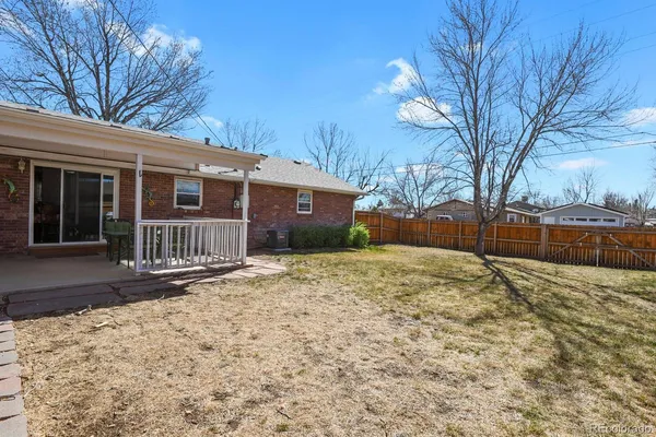 a view of a house with a yard covered in snow
