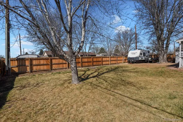 a view of a yard with wooden fence