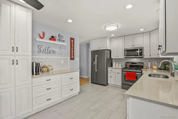 a kitchen with refrigerator and cabinets