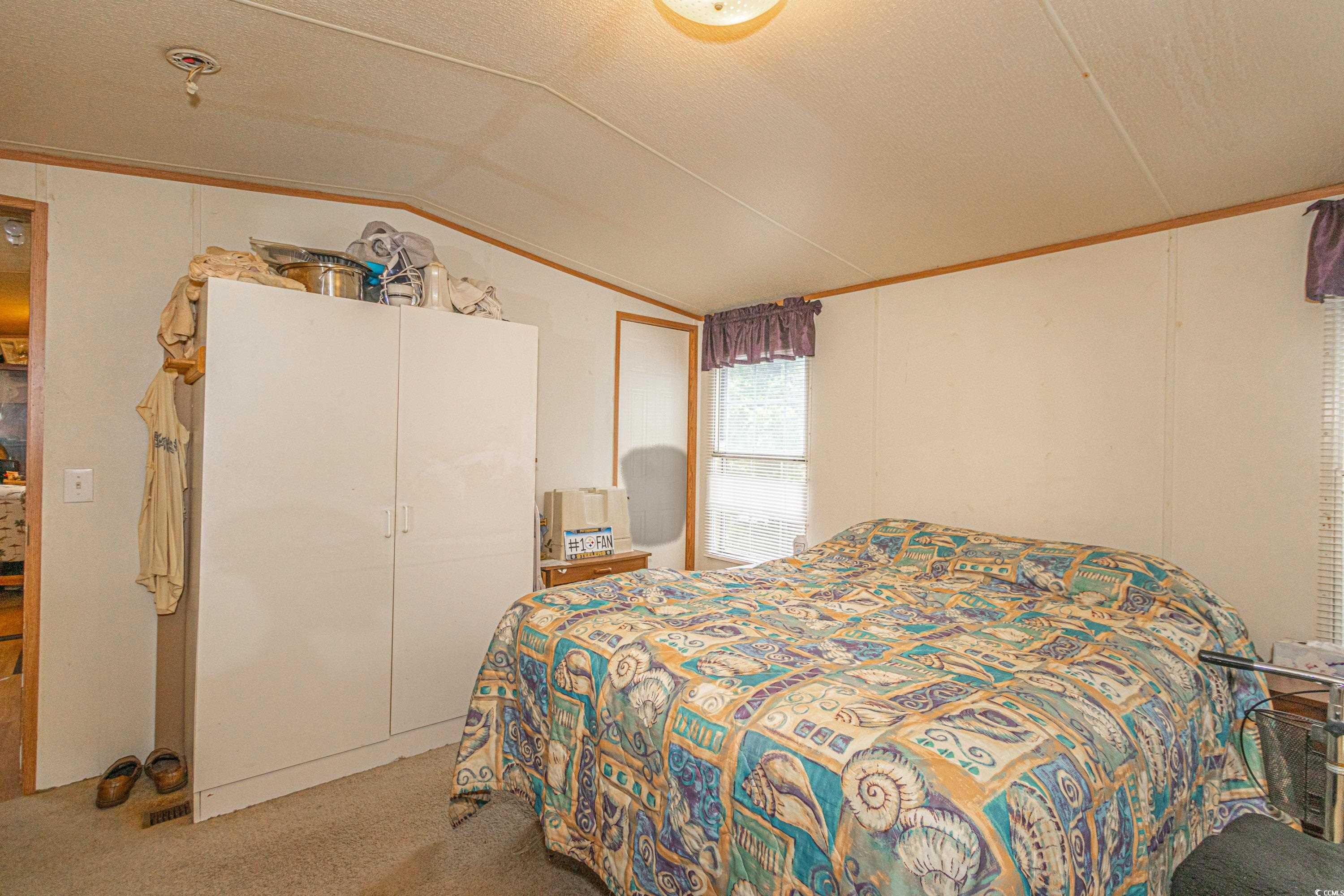 98 Offshore Drive Murrells Inlet, SC 29576 - Photo 13 of 27 Bedroom featuring lofted ceiling and carpet floors