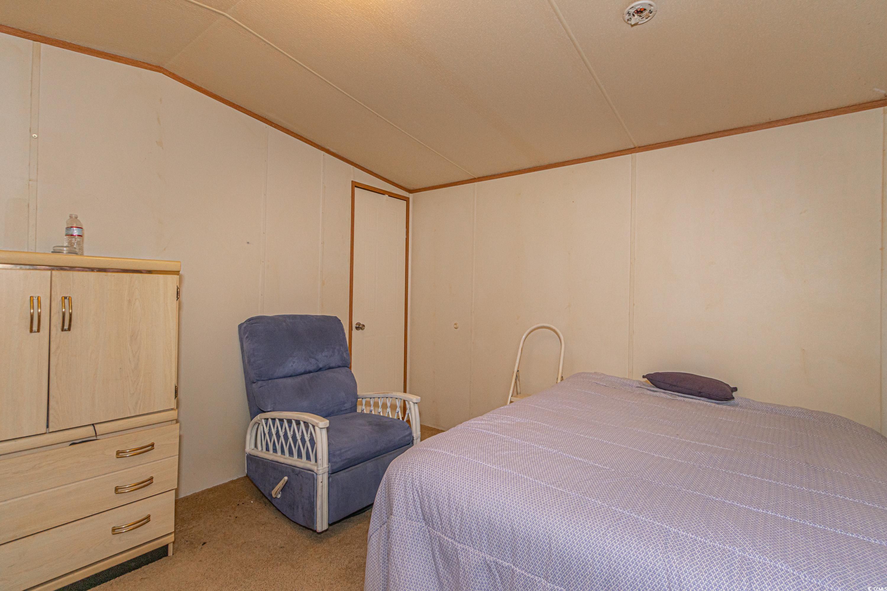 98 Offshore Drive Murrells Inlet, SC 29576 - Photo 18 of 27 Bedroom featuring vaulted ceiling and light carpet