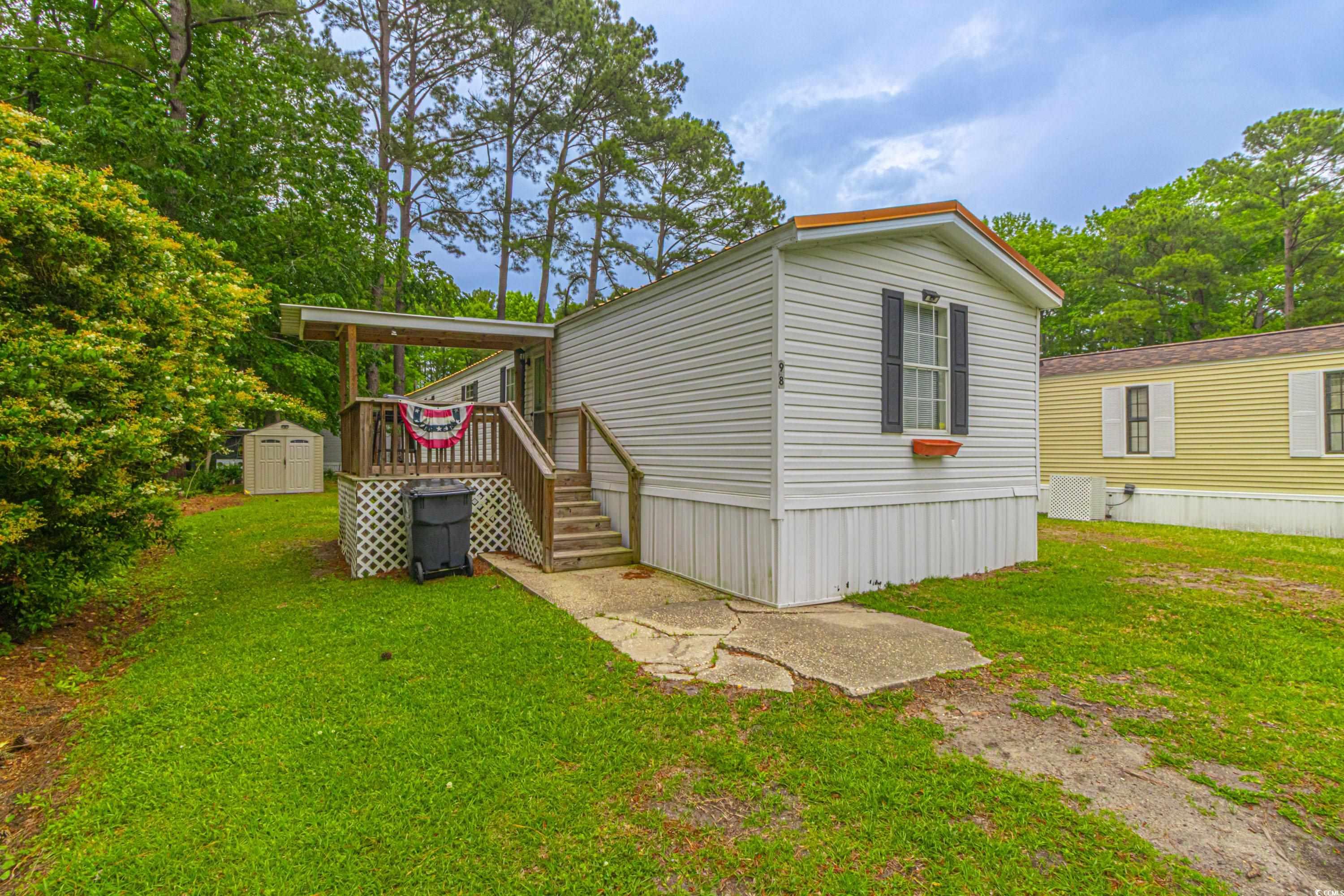98 Offshore Drive Murrells Inlet, SC 29576 - Photo 22 of 27 View of side of home with a storage unit, an outdo