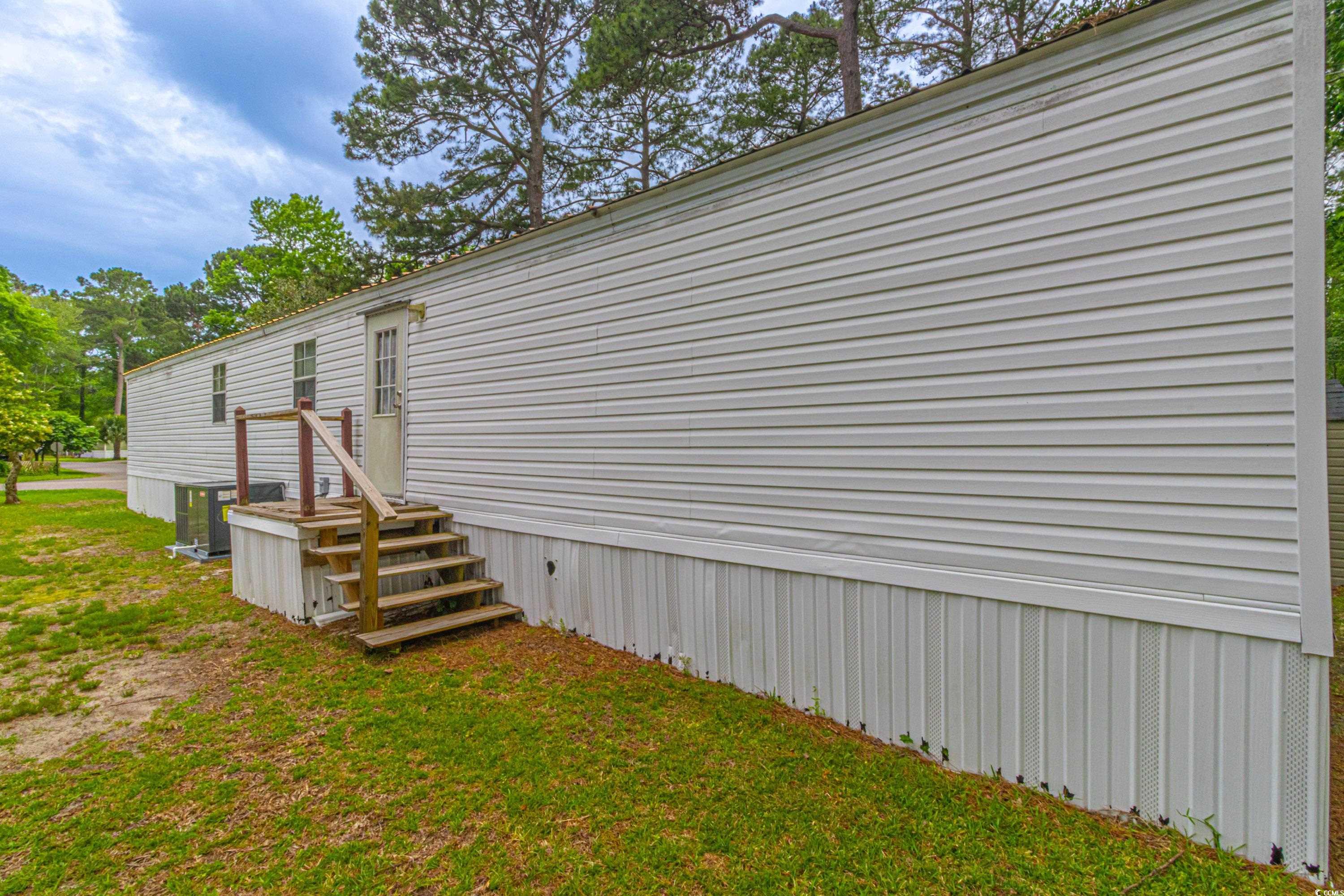 98 Offshore Drive Murrells Inlet, SC 29576 - Photo 24 of 27 View of side of property with cooling unit and a l