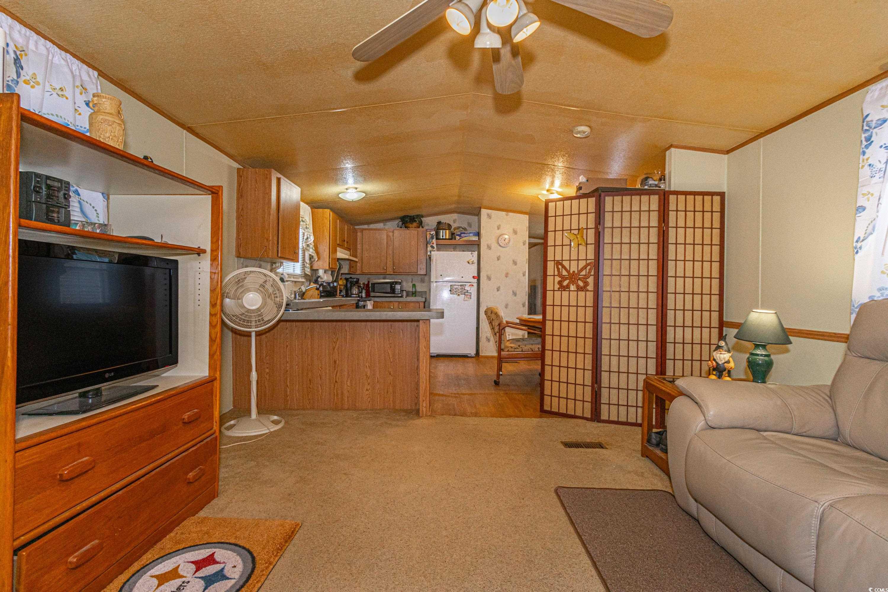 98 Offshore Drive Murrells Inlet, SC 29576 - Photo 3 of 27 Living room with vaulted ceiling, ceiling fan, lig