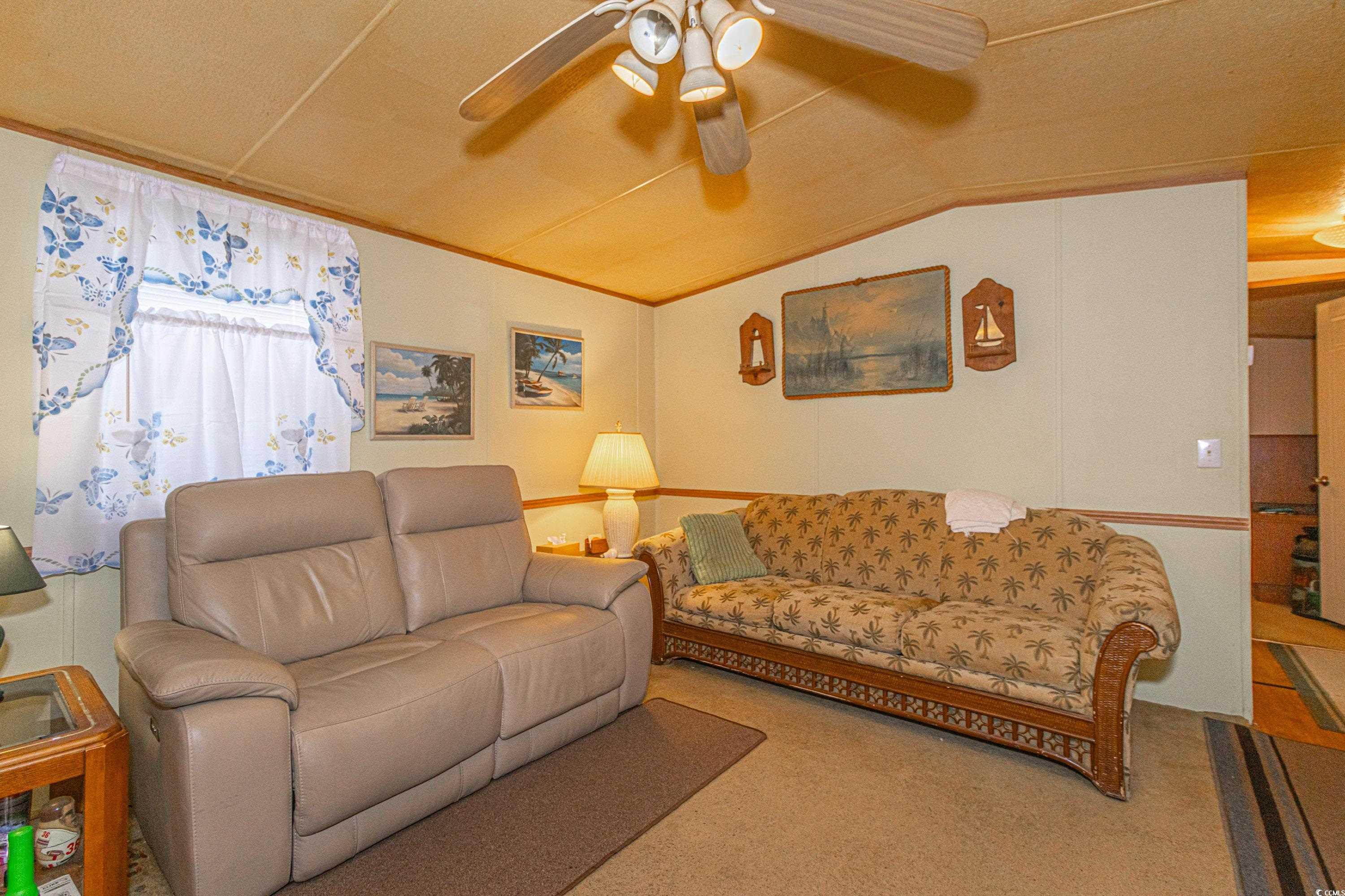 98 Offshore Drive Murrells Inlet, SC 29576 - Photo 4 of 27 Living room with ceiling fan, lofted ceiling, and