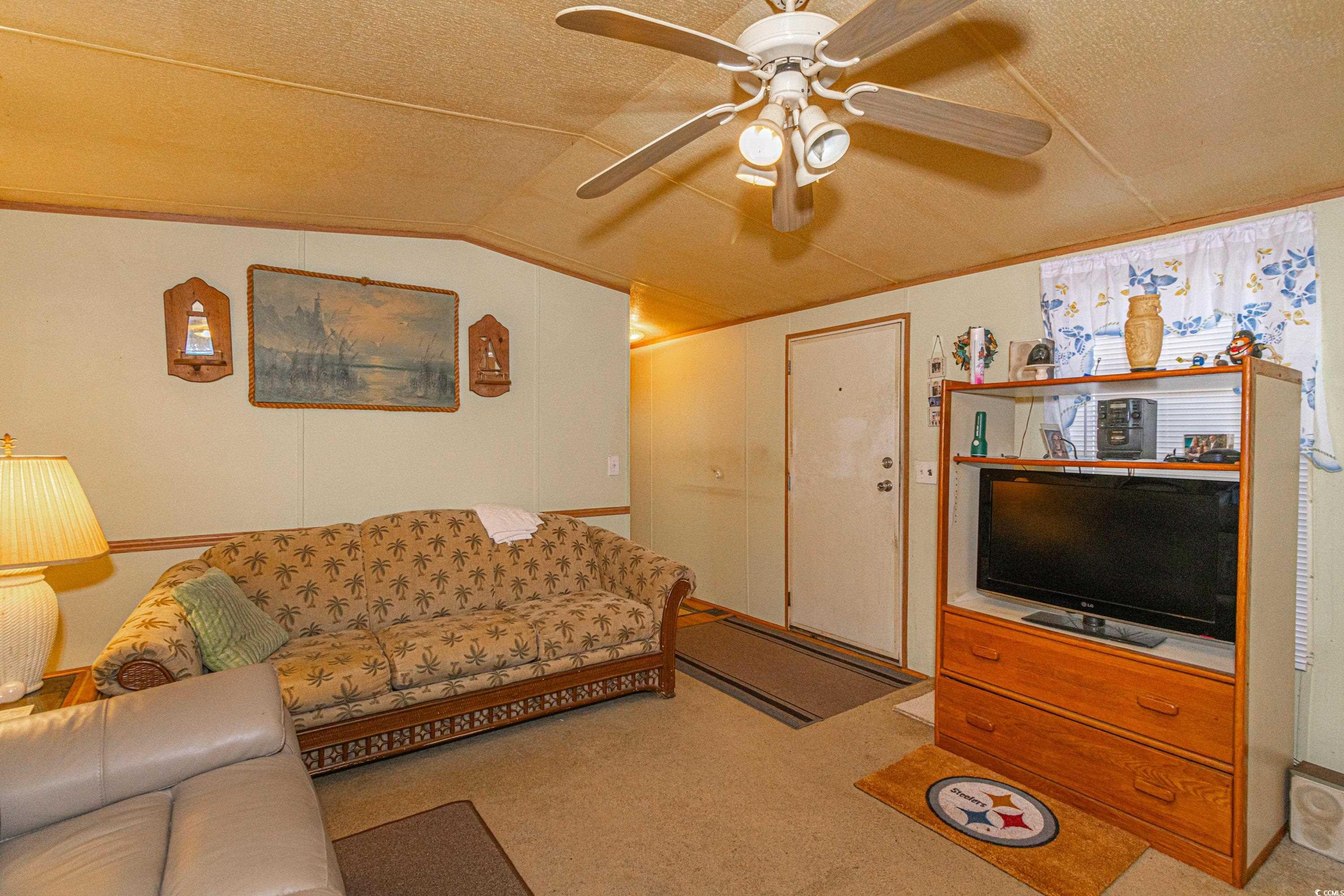 98 Offshore Drive Murrells Inlet, SC 29576 - Photo 5 of 27 Carpeted living room with ceiling fan, lofted ceil