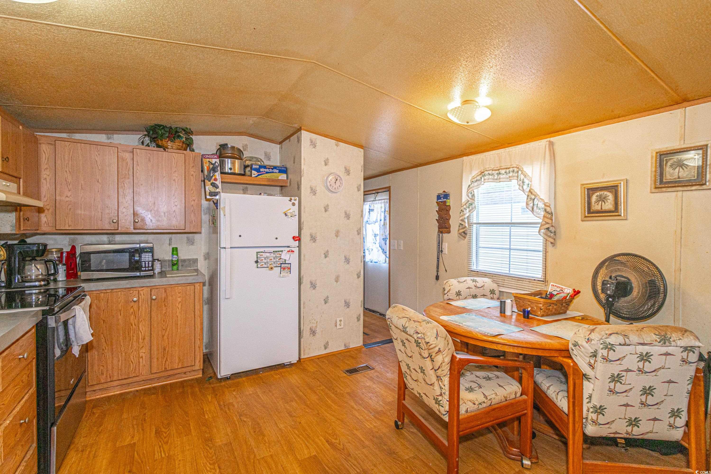 98 Offshore Drive Murrells Inlet, SC 29576 - Photo 7 of 27 Kitchen with freestanding refrigerator, range with
