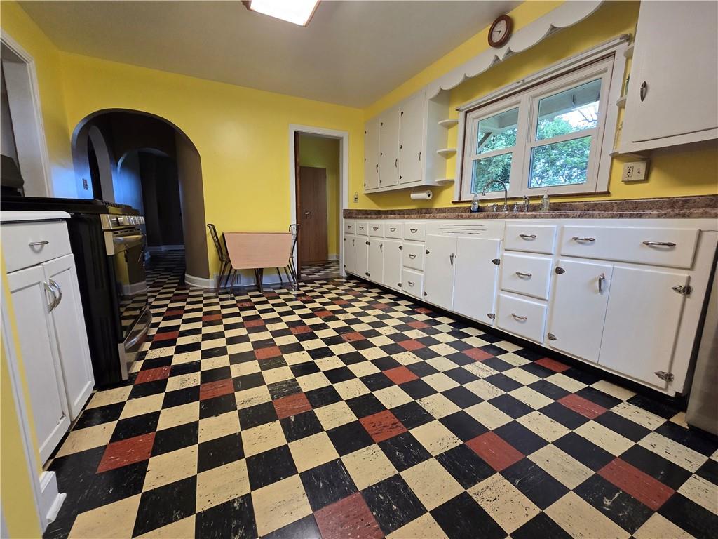 368 Pittsburgh Road Butler, PA 16002 - Photo 4 of 20 a kitchen with a checkered floor and white cabinets