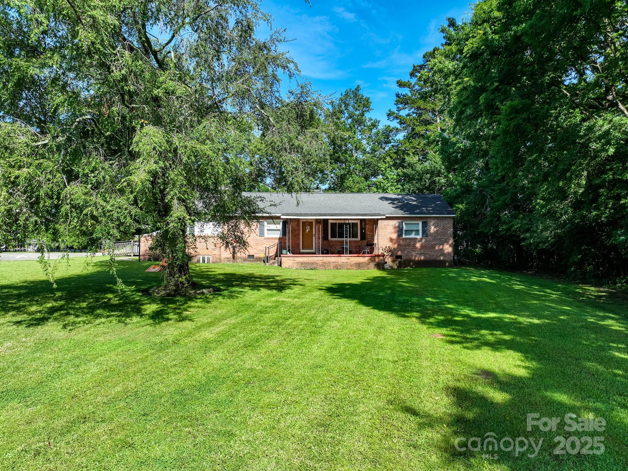 a front view of house with yard and green space