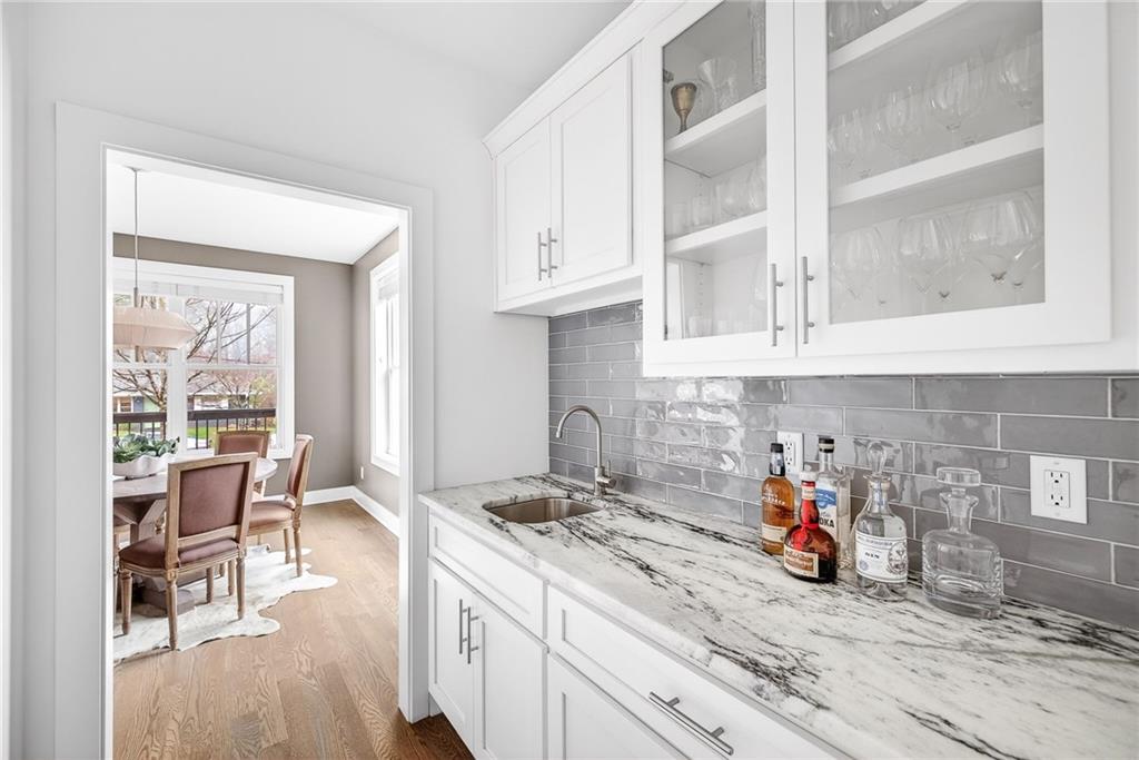 209 Ridgeland Avenue Decatur, GA 30030 - Photo 11 of 23 a kitchen with furniture a stove a refrigerator and a dining table next to a window